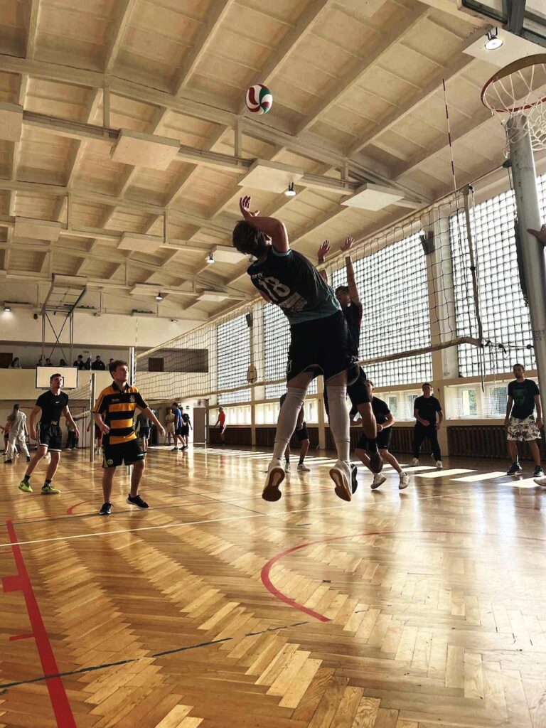 Uczeń odbija piłkę podczas zawodów siatkarskich. 